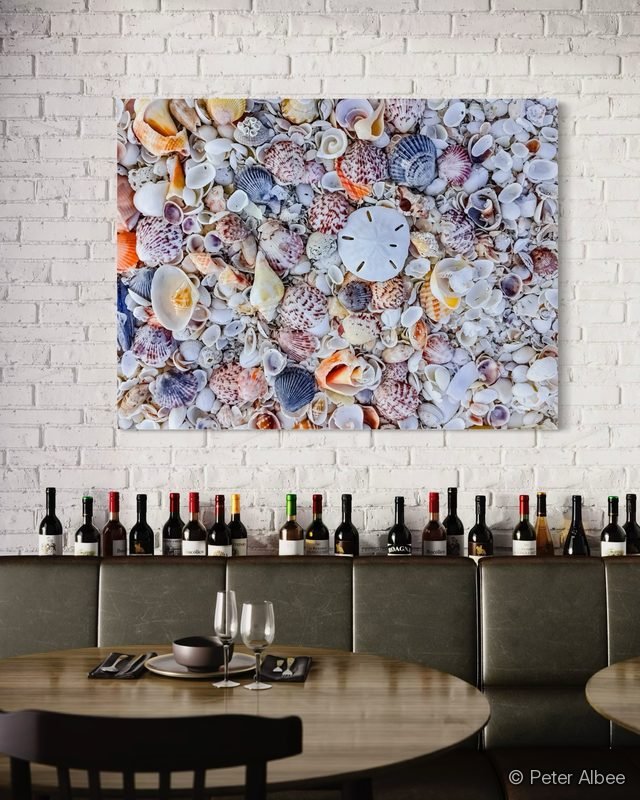 Shell & Sand Dollar Mosaic printed as canvas art, hung in a dining room, wine wall — room mockup